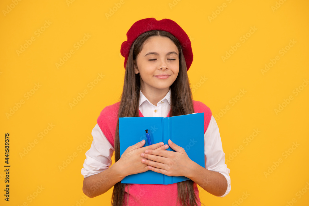 childhood happiness. back to school. dreamy kid in beret ready to study. smiling child making notes childhood happiness. back to school. dreamy kid in beret ready to study. smiling child making notes