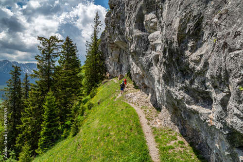 Hikers on hiking trail under massive rock in Low Tatras mountains, Slovakia photo