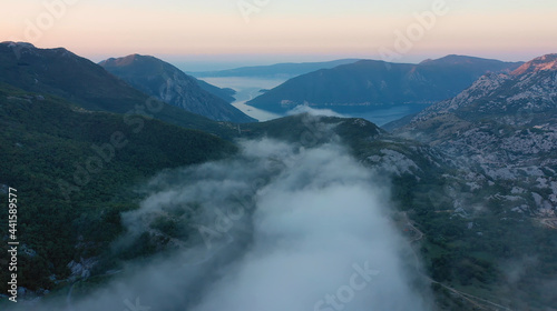 Aerial view of mesmerizing landscape of mountains of setting sun and white clouds on a warm summer evening. Concept of pristine nature and relaxation in ecologically clean corners of the planet © skymediapro