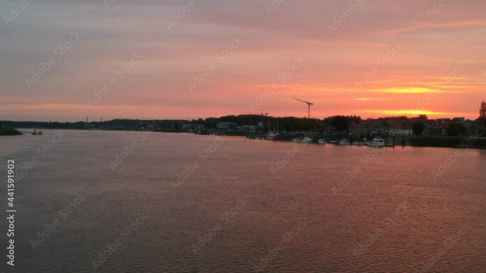 Golden color sky and coastal city silhouette in aerial drone view Golden color sky and coastal city silhouette in aerial drone view