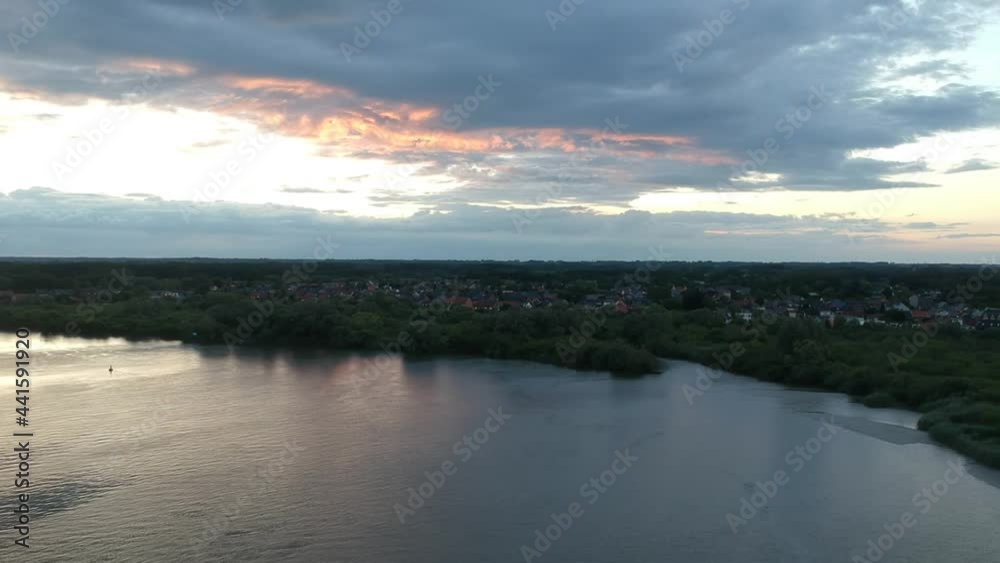Majestic colorful clouds after sunset over small coastal town, aerial view Majestic colorful clouds after sunset over small coastal town, aerial view