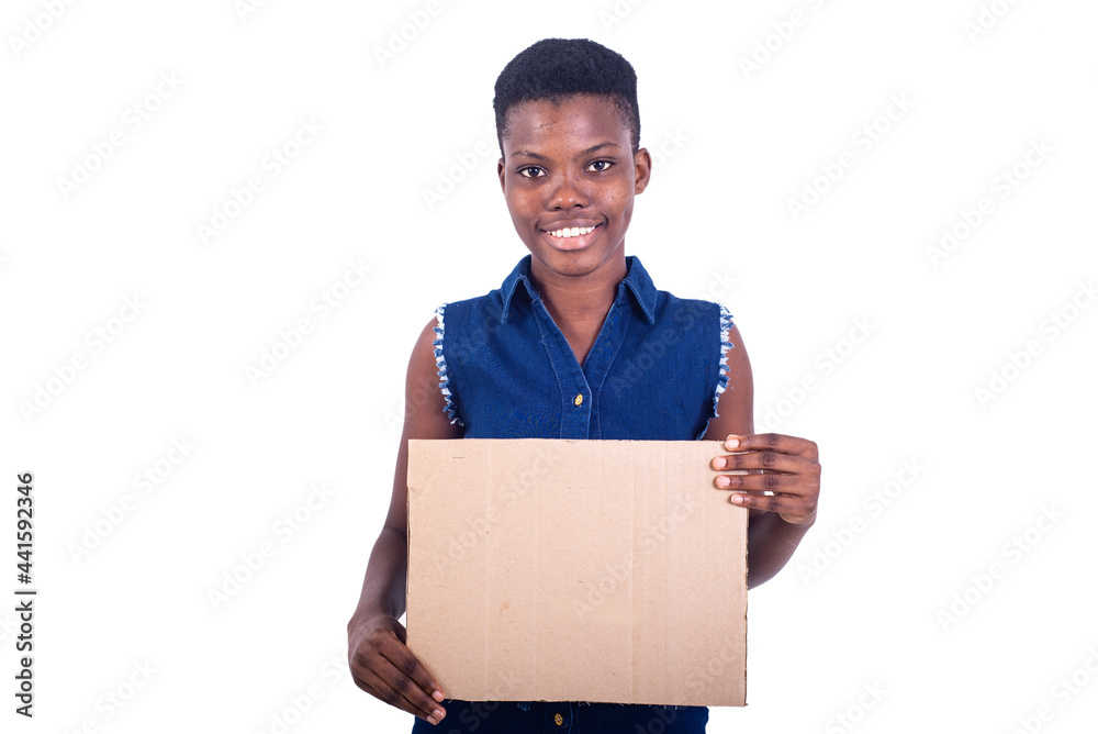 beautiful girl holding a piece of blank cardboard smiling. beautiful girl holding a piece of blank cardboard smiling.
