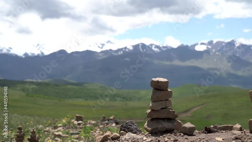 a tower of stones on the background of mountains