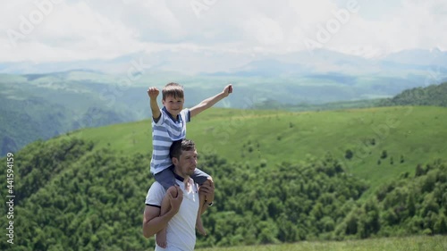 a child on dad's shoulders in the mountains