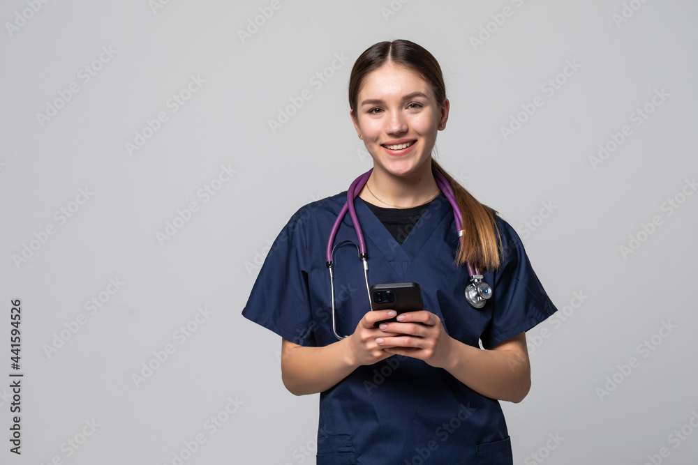 Young woman medical doctor use mobile phone isolated on white background. - obrazy, fototapety, plakaty 