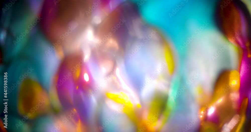 Stained glass rainbow ornament sphere moving texture, 3 clips, one in focus and 2 out of focus, bokeh background