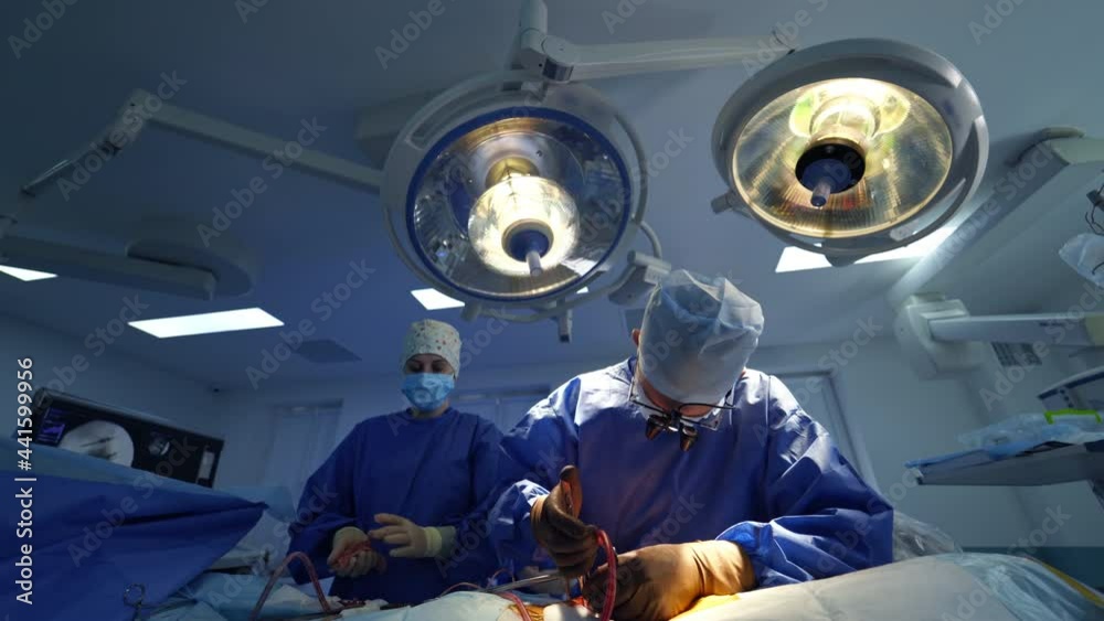 Team surgeon at work in operating room. Neurosurgery doctors hard working in operation ward. Team surgeon at work in operating room. Neurosurgery doctors hard working in operation ward.