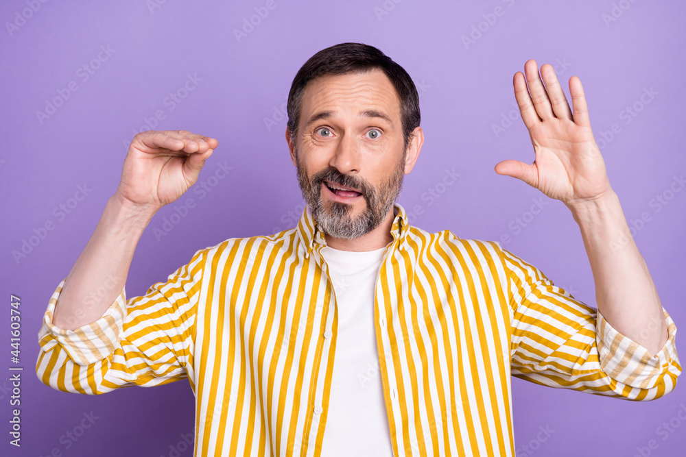 Fototapeta premium Photo of sweet excited mature man dressed striped shirt showing arms be quiet isolated violet color background
