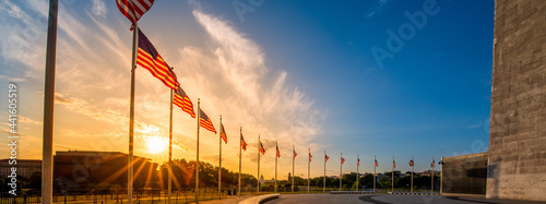 Sunrise over ring of American Flags around the Washington Monument in United States capitol with national mall and Smithsonian Museums in background. photo