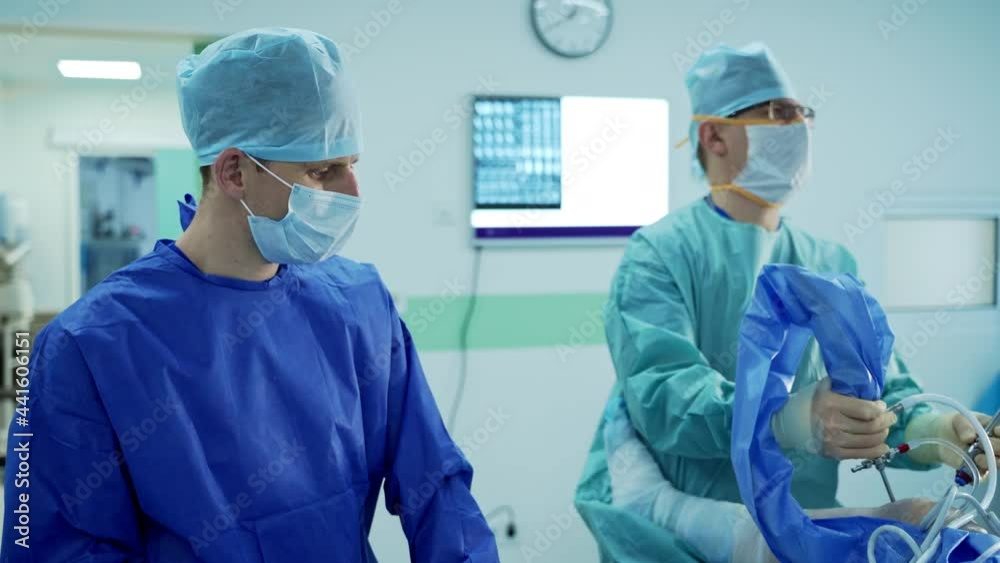 Team of surgeons working together in operating room. Surgery emergency treatment. Team of surgeons working together in operating room. Surgery emergency treatment.