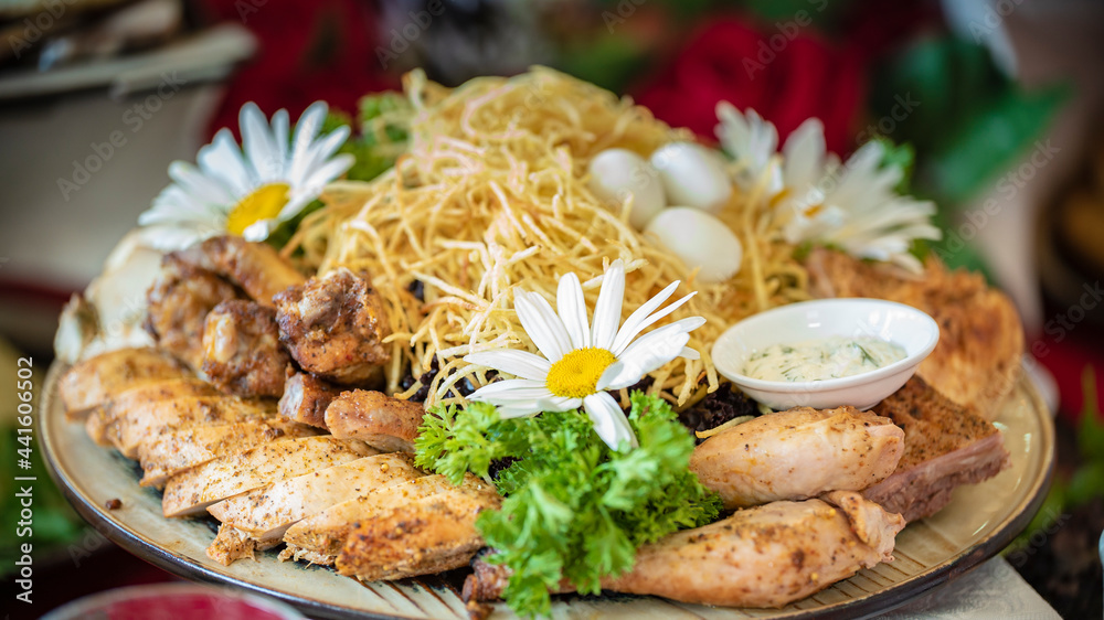 Chicken pieces, chicken legs with French fries, garnished with lettuce and chamomile flowers. Chicken pieces, chicken legs with French fries, garnished with lettuce and chamomile flowers.