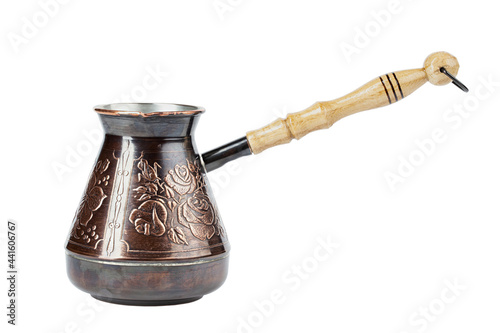 Old copper coffee pot with a wooden handle on isolated on white background.