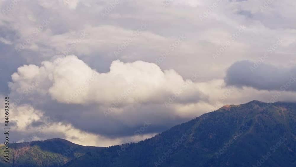 Timelapse of clouds moving over mountain tops as light fades blocking the sun in Utah. Timelapse of clouds moving over mountain tops as light fades blocking the sun in Utah.
