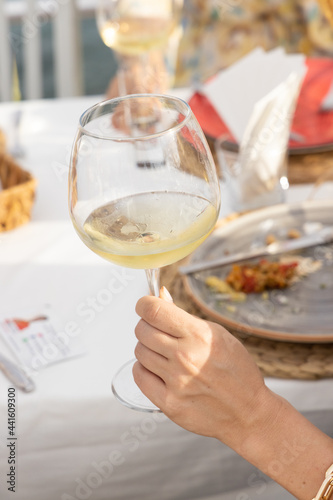 a woman drinking a white wine