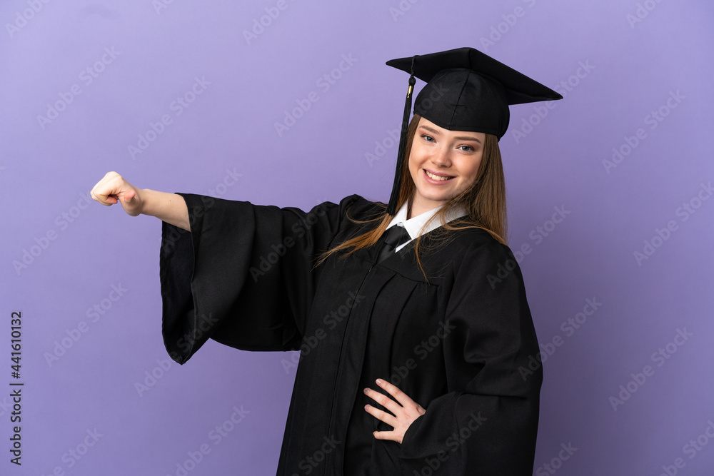 Young university graduate over isolated purple background giving a thumbs up gesture Young university graduate over isolated purple background giving a thumbs up gesture