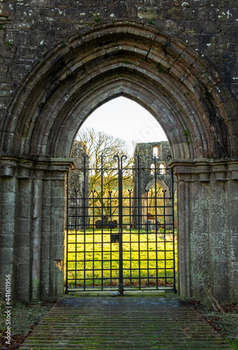 Gated archway entrance at Dundrennan Abbey, a medieval abbey, Scotland photo