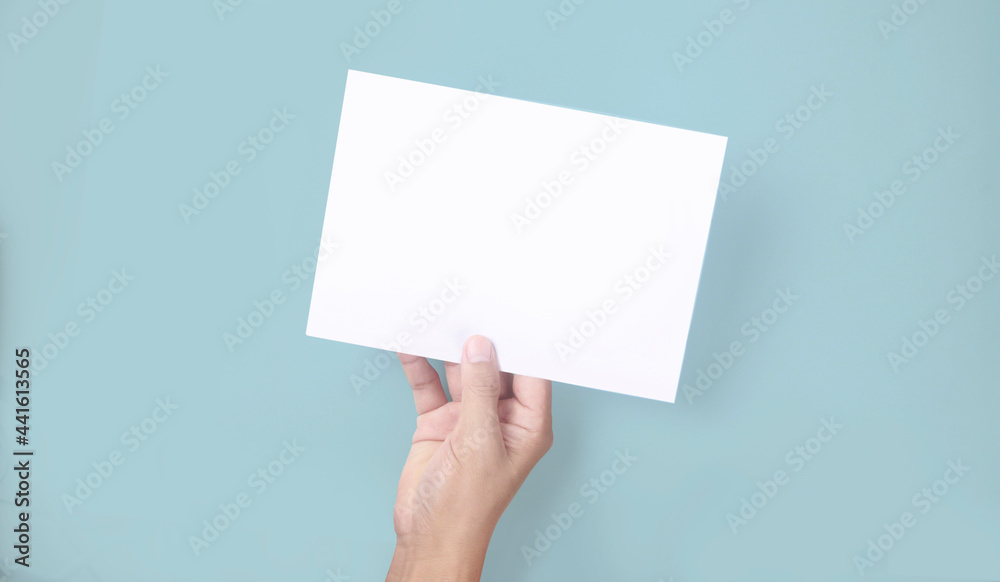 Fototapeta premium Hands holding paper blank for letter paper