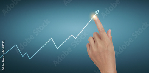 Hand touching graphs of financial indicator and accounting market chart
