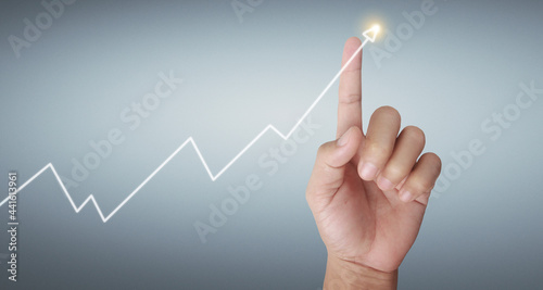 Hand touching graphs of financial indicator and accounting market  chart
