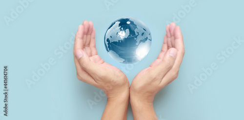 Glass globe in hand Energy saving concept  by NASA