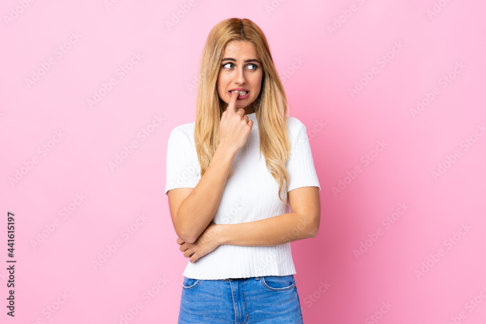 Young Uruguayan blonde woman over isolated pink background nervous and scared Young Uruguayan blonde woman over isolated pink background nervous and scared