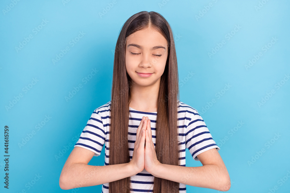 Photo of young attractive school girl happy positive smile dream dreamy make wish isolated over blue color background Photo of young attractive school girl happy positive smile dream dreamy make wish isolated over blue color background
