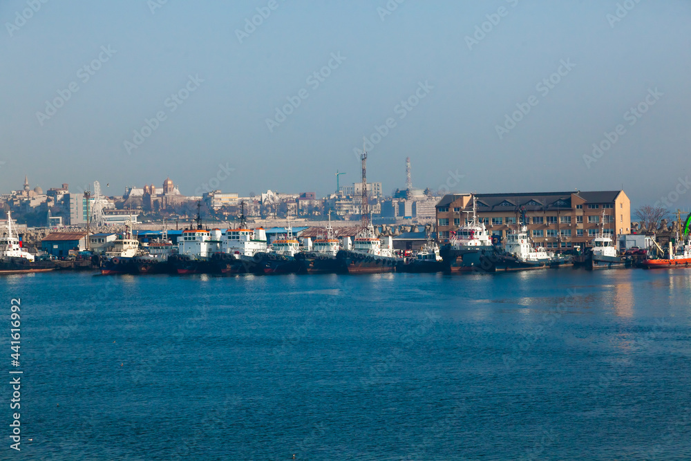 There are many tugs at the pier in the port of Constanta Romania.