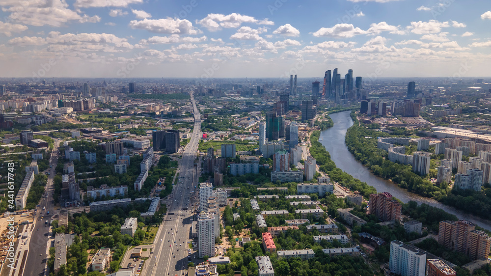 Fototapeta premium Beautiful city landscape from above. Tall houses and green parks. Sunny day. Beautiful city.