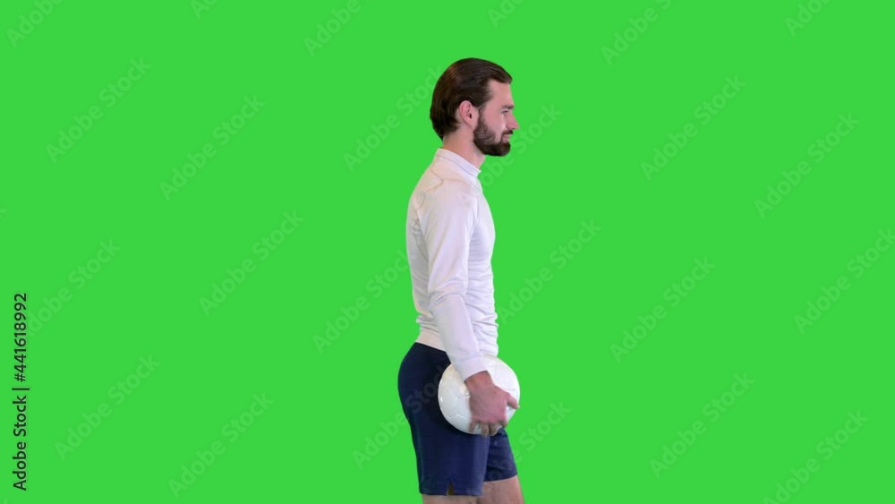 Soccer player with a bag in hands walking on a Green Screen, Chroma Key. Soccer player with a bag in hands walking on a Green Screen, Chroma Key.