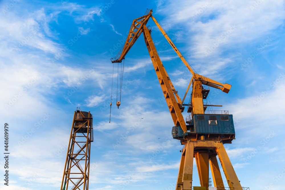 Harbor crane on a background of blue sky, bottom view. Harbor crane on a background of blue sky, bottom view.