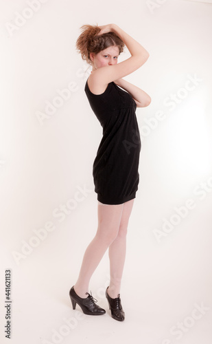 slim teenager girl in a black dress