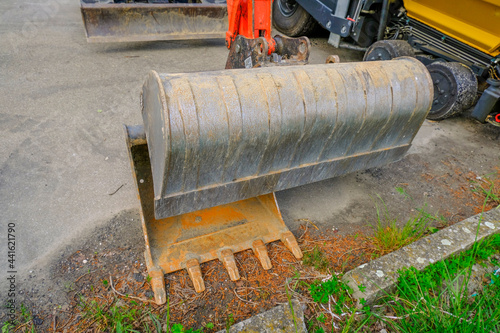 Excavator bailer close-up on asphalt. Heavy machinery industry