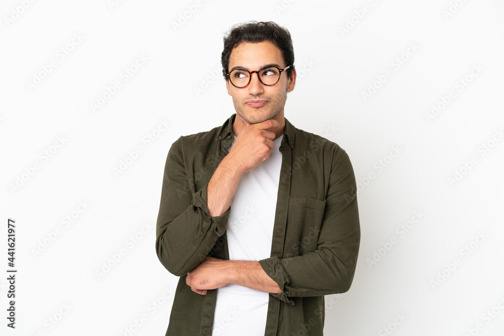 Caucasian handsome man over isolated white background thinking an idea while looking up Caucasian handsome man over isolated white background thinking an idea while looking up