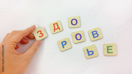 hand holding the letter word health on a light background 