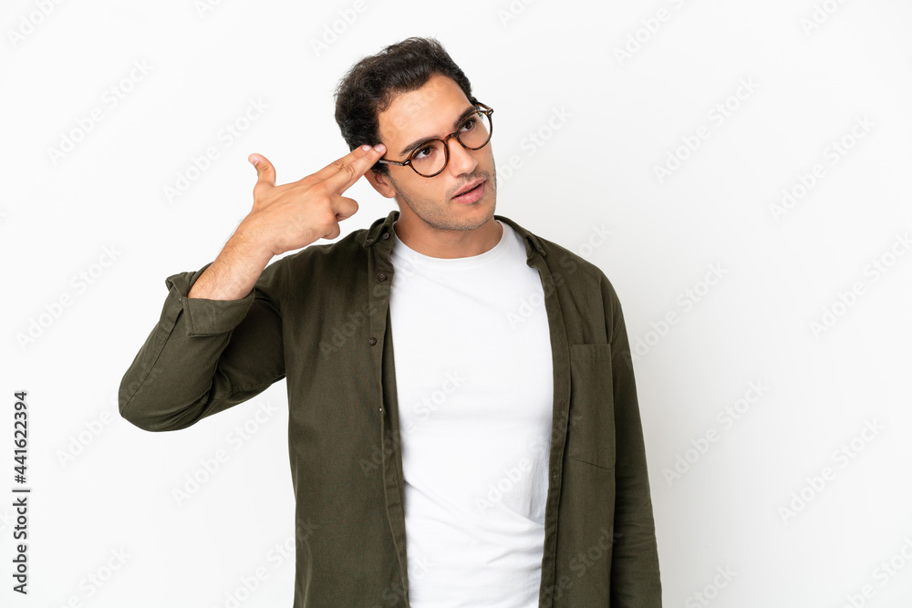 Caucasian handsome man over isolated white background with problems making suicide gesture Caucasian handsome man over isolated white background with problems making suicide gesture