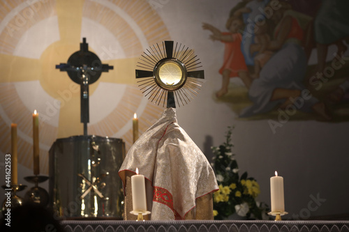 A priest holding a monstrance in the Church  photo