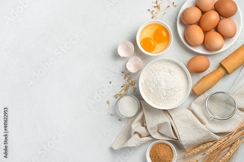 Ingredients for making dough dishes: cakes, cookies, pizza, pasta on a gray background.