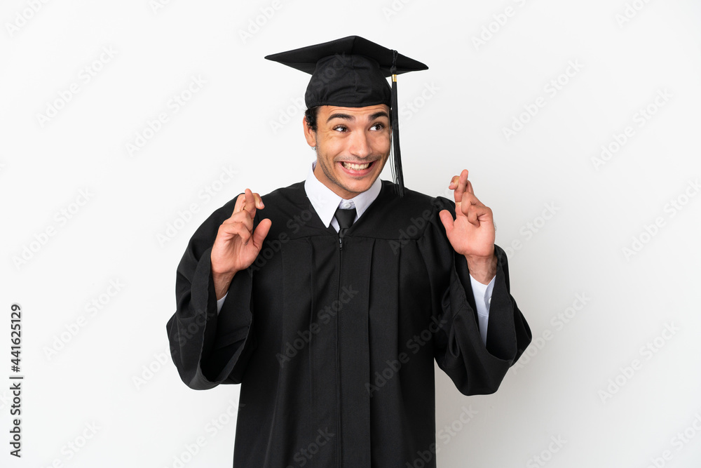 Young university graduate over isolated white background with fingers crossing Young university graduate over isolated white background with fingers crossing