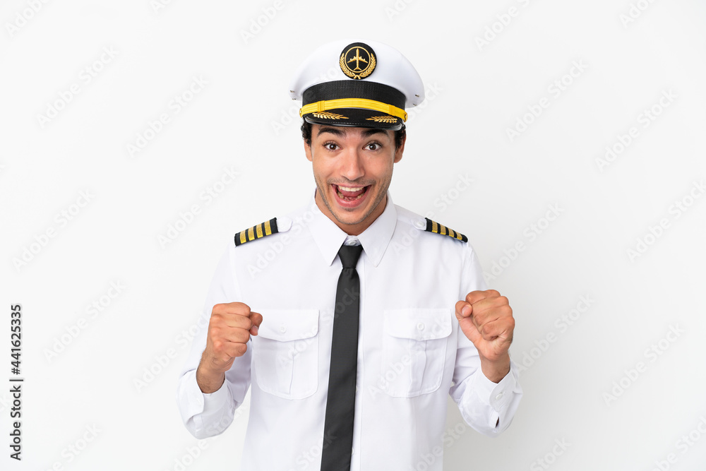 Airplane pilot over isolated white background celebrating a victory in winner position