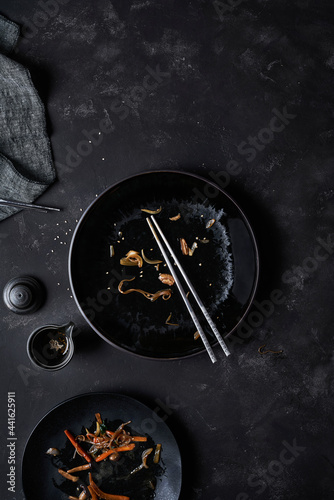 Empty plate with chopsticks after Japchae dish photo