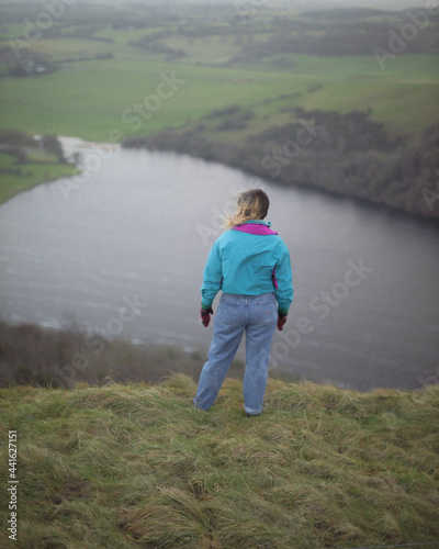 girl standing on hill top 