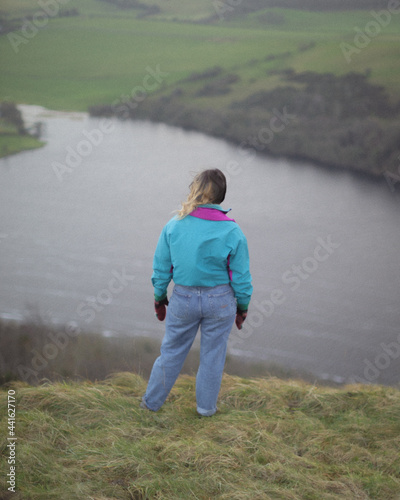 girl standing on hill top 