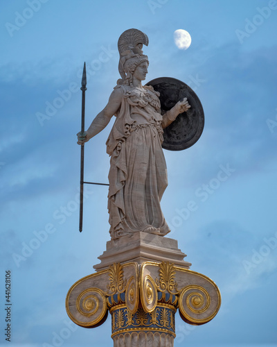 Athena the ancient Greek goddess of wisdom and knowledge, moon still on the sky, Athens Greece