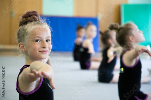 Girls gymnasts doing workout in gym on training