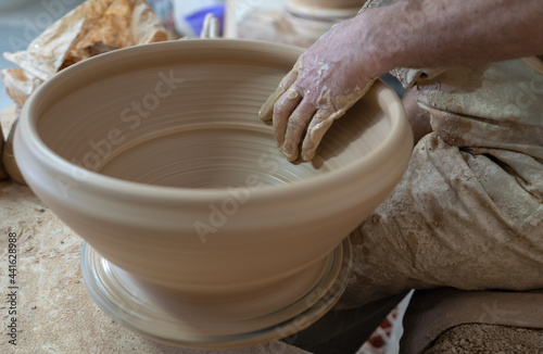 Fotografie Potter working softly on pot with hand