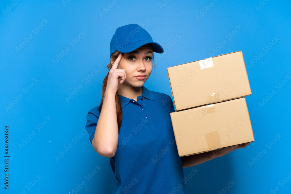 Delivery girl over isolated blue wall thinking an idea Delivery girl over isolated blue wall thinking an idea