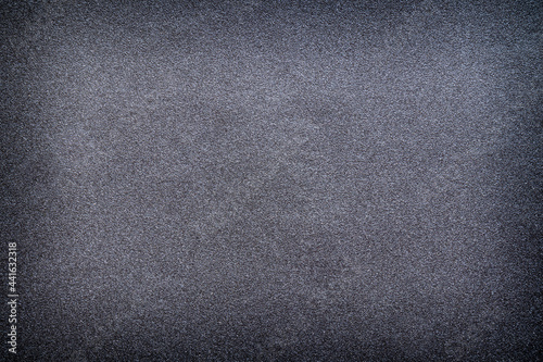 Sandpaper texture background gives a beautiful pattern of black sand grains on sandpaper, suitable as a background for inserting text. Copy Space for designers to use on sandpaper.