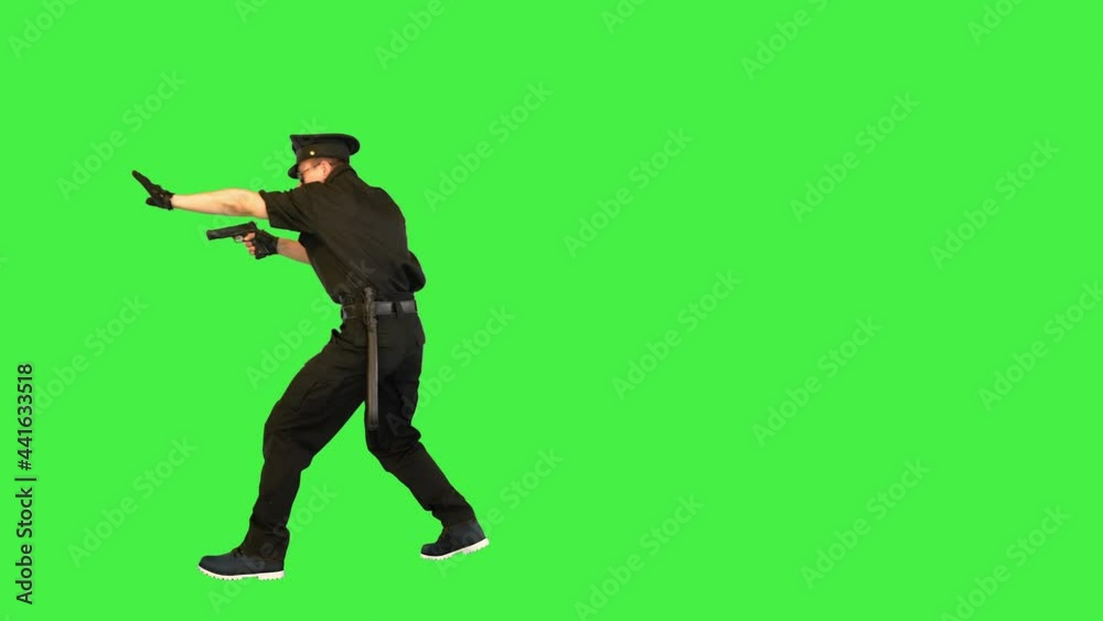 White policeman walks, getting the gun out, giving an order on a Green Screen, Chroma Key. White policeman walks, getting the gun out, giving an order on a Green Screen, Chroma Key.