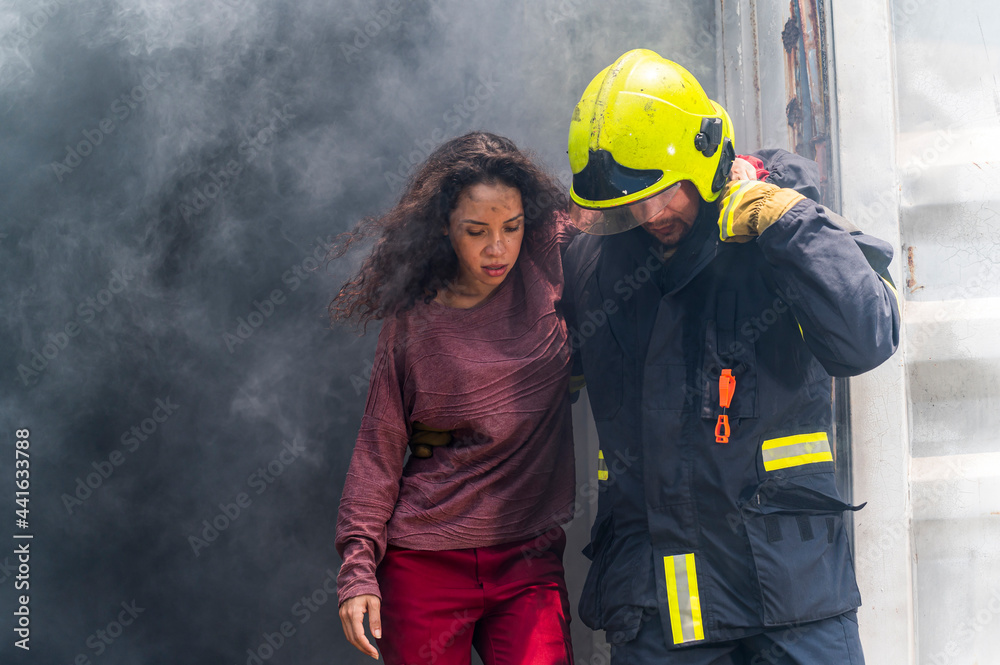 Firefighter emergency rescue help young woman from dangerous smoke and burning building accident. - Safety and rescue operation comcept