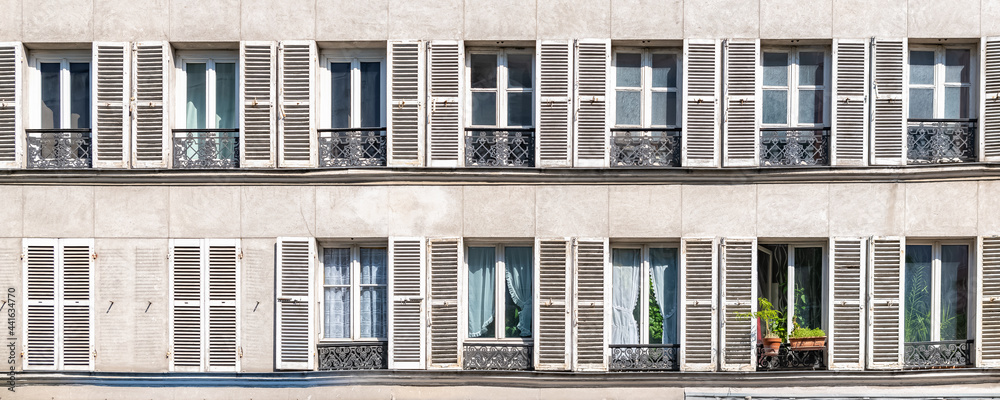 Paris, beautiful facade in the Marais, detail of the windows
